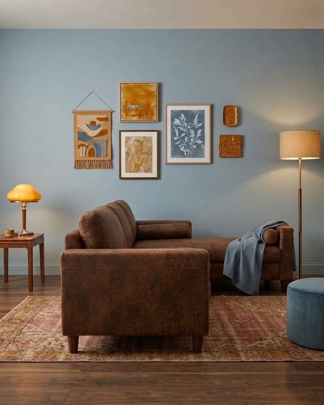 Brown leather sectional sofa and blue ottoman against a light blue wall.