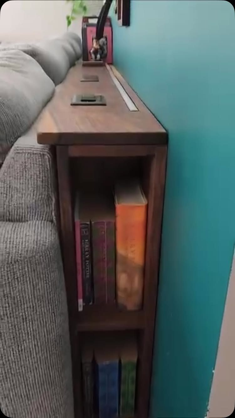 13 Cube Organizer Ideas for Your Living Room Layout 11 Dark wood cube organizer shelf with books between a grey sofa and turquoise wall