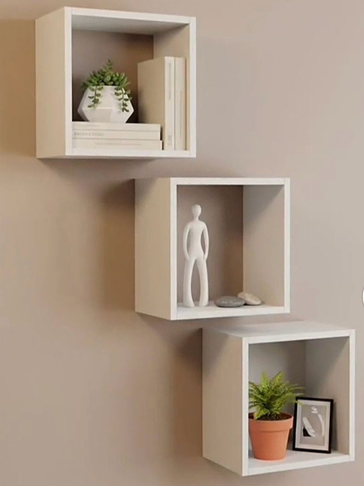 13 Cube Organizer Ideas for Your Living Room Layout 8 Three white cube organizers mounted on a wall with plants and decor.