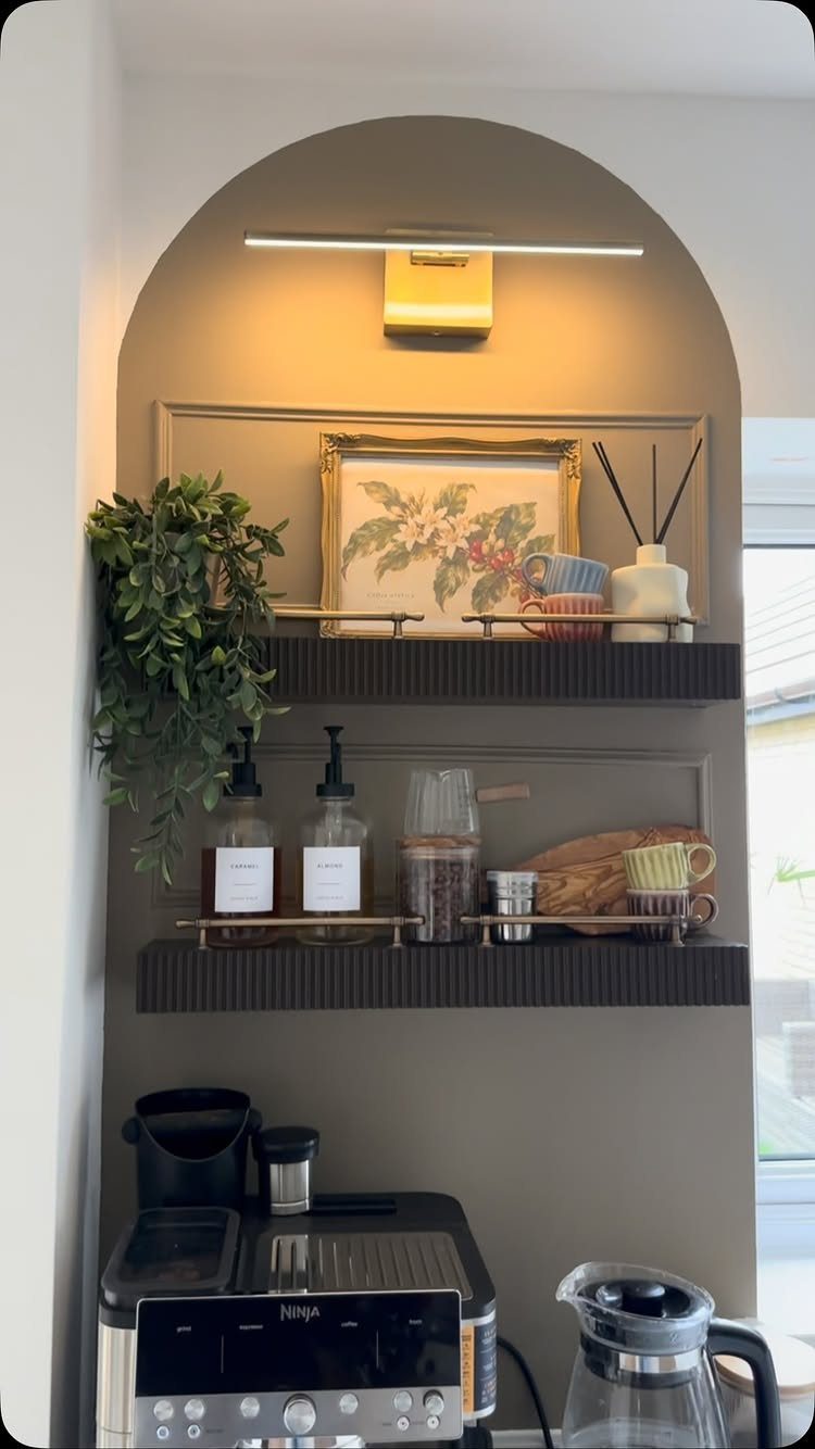 Wall Mounted Coffee Bar: 23 Stylish Space-Saving Ideas 15 Coffee station in an arched alcove with floating shelves and a gold picture light.